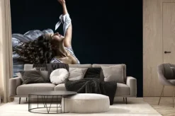 Fototapeta: Beautiful brunette girl with curly hair in the darkness and light