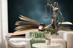 Fototapeta: Closeup of a sculpture of themis, book and gavel, symbol of justice