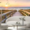 Fototapeta: Drewniany most i ptaki na tle zachodu słońca nad morzem