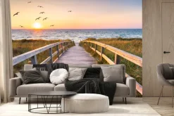 Fototapeta: Drewniany most i ptaki na tle zachodu słońca nad morzem