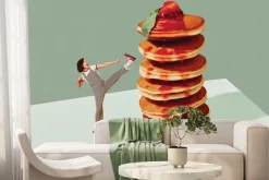 Fototapeta: Kobieta kopiącą w górę naleśników