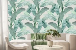 Fototapeta: Liście bananowca na betonowym tle w szarości