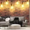 Fototapeta: Many pendant lamps against red brick wall