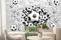 Fototapeta: Piłki nożne przebijające ceglany mur 3d