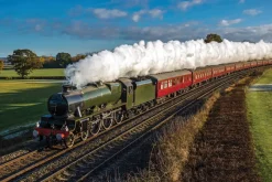 Fototapeta: Pociąg parowy jadący przez pola