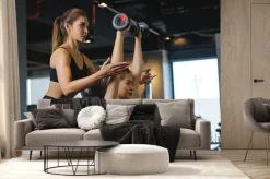 Fototapeta: Sporty girl doing weight exercises with the help of her personal