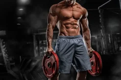 Fototapeta: Umięśniony mężczyzna z ciężarami