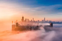 Fototapeta: Wschód słońca w zamglonej metropolii