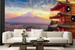 Fototapeta: Zachód słońca na tle gór i kwiatów wiśni