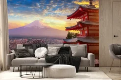 Fototapeta: Zachód słońca na tle gór i kwiatów wiśni