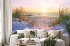 Naklejka: Piaszczysta plaża z widokiem na morze o zachodzie słońca