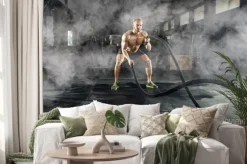 Naklejka: Sportowy młody człowiek z batalistyczną arkaną robi ćwiczeniu