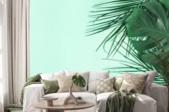 Naklejka: Summer composition. palm leaves on mint background. summer concept.