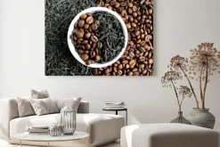 Obraz: Coffee beans and tea in leaves on the same plate