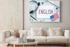 Obraz: English lessons concept. headpones with notebook on student table