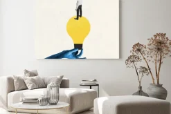 Obraz: Female blue hand holding electric bulb as idea symbol with young