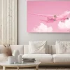Obraz: Pastel pink plane flying in the sky with clouds. plane take off