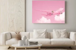 Obraz: Pastel pink plane flying in the sky with clouds. plane take off