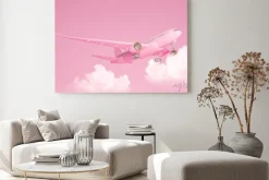 Obraz: Pastel pink plane flying in the sky with clouds. plane take off