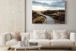 Obraz: Wooden footpath to lighthouse winding among heaps of coastal