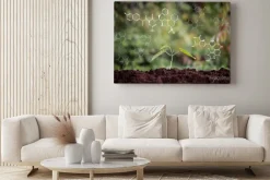 Obraz: Young plant growing from soil with chemical formula screen, ecology