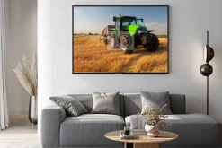 Plakat: Modern green tractor on agricultural field during harvest on