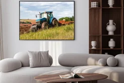 Plakat: Niebieski traktor na polu uprawnym w dzień